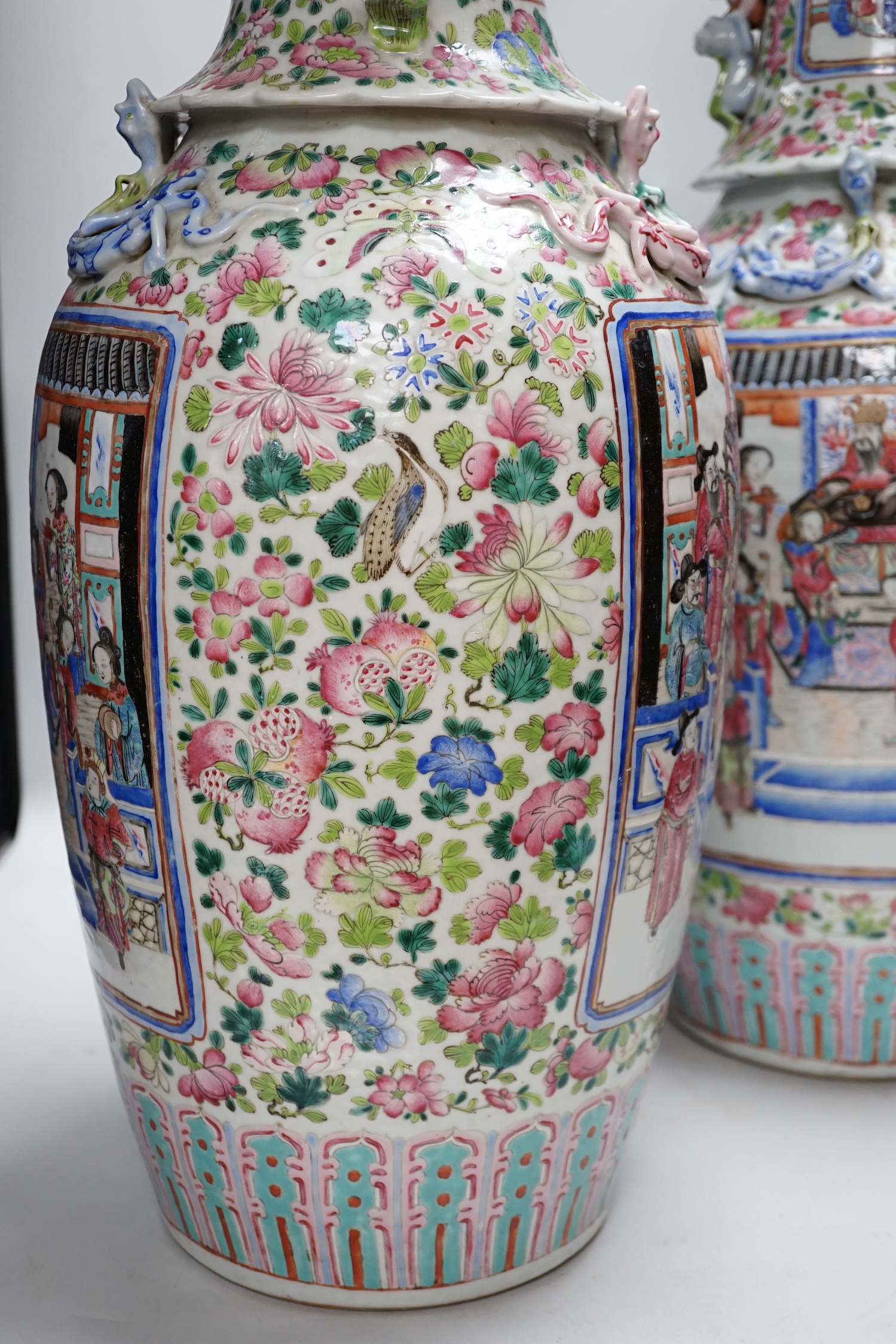 A pair of large Chinese porcelain famille rose vases, 19th century, decorated with court scenes and flowers, 61cm high